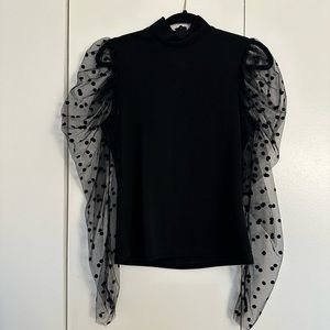 Black mock-neck top with sheer puff sleeves